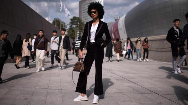 An attendee poses for a photo during Seoul Fashion Week at Dongdaemun Design Plaza in Seoul on October 19, 2017. (Ed Jones / AFP)