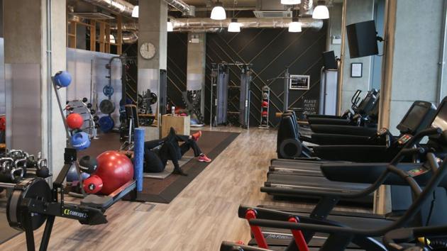 People are seen exercising at the gym area of the building. The co-living building also boasts of high-end facilities such as a spa, library, work room, restaurant and even a cinema, which is packed for evening screenings of the hit TV series Game of Thrones. (Daniel Leal-Olivas / AFP) People are seen exercising at the gym area of the building. The co-living building also boasts of high-end facilities such as a spa, library, work room, restaurant and even a cinema, which is packed for evening screenings of the hit TV series Game of Thrones. (Daniel Leal-Olivas / AFP)