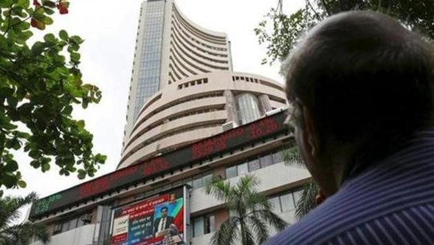 A man looks at a screen across a road displaying the Sensex on the facade of the Bombay Stock Exchange (BSE) building in Mumbai. (Reuters) A man looks at a screen across a road displaying the Sensex on the facade of the Bombay Stock Exchange (BSE) building in Mumbai. (Reuters)