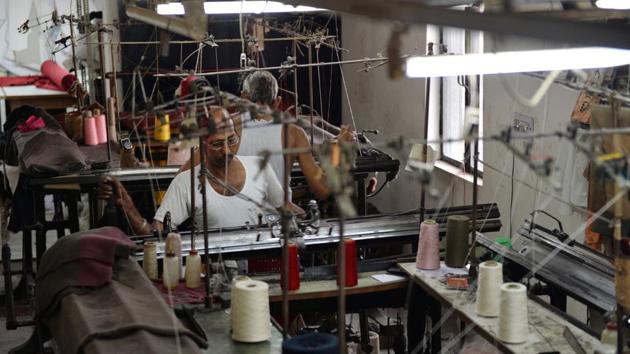 In this picture taken on September 25, 2017, a man works at a garment factory in Ludhiana. Over the last year, Prime Minister Narendra Modi has rolled out controversial reform measures that have affected small traders.(AFP)