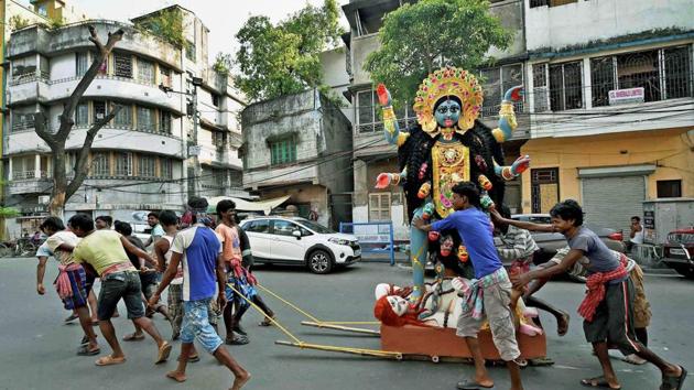 The idol of Goddess Kali being carried to a pandal from a workshop in Kolkata on Tuesday ahead of Kali puja. (Swapan Mahapatra / PTI) The idol of Goddess Kali being carried to a pandal from a workshop in Kolkata on Tuesday ahead of Kali puja. (Swapan Mahapatra / PTI)