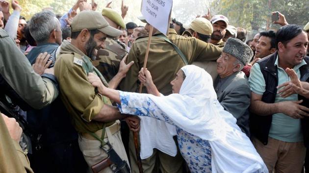 National Conference workers scuffle with police during their protest rally against the growing incidents of braid chopping in Kashmir valley,in Srinagar on Saturday. (PTI) National Conference workers scuffle with police during their protest rally against the growing incidents of braid chopping in Kashmir valley,in Srinagar on Saturday. (PTI)