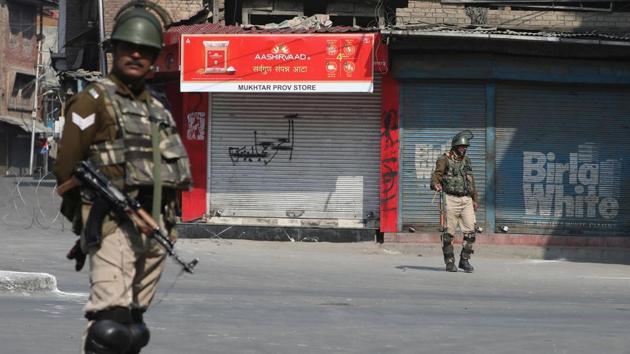 Paramilitary soldiers stands guard during restrictions in downtown Srinagar on Saturday. Authorities imposed restrictions in parts of downtown Srinagar as separatists had called for a shutdown against braid chopping incidents in Kashmir. So far, 100 incidents of braid chopping have cropped. (Waseem Andrabi/ HT File Photo)