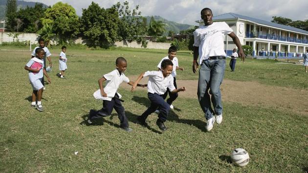 Usain Bolt plays football with schoolchildren, during a visit to the Emmanuel Prep School on October 18, 2006 in Kingston, Jamaica. (Getty Images) Usain Bolt plays football with schoolchildren, during a visit to the Emmanuel Prep School on October 18, 2006 in Kingston, Jamaica. (Getty Images)