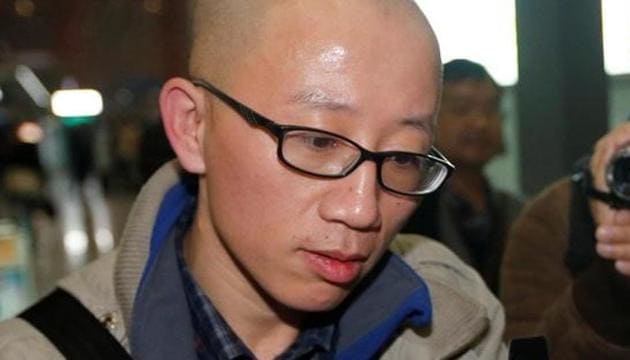Chinese dissident Hu Jia uses his mobile phone at Beijing airport November 6, 2013. (Reuters File Photo)