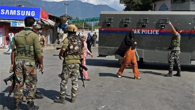 Security personnel at the scene of a grenade blast at Tral in Kashmir.(PTI)