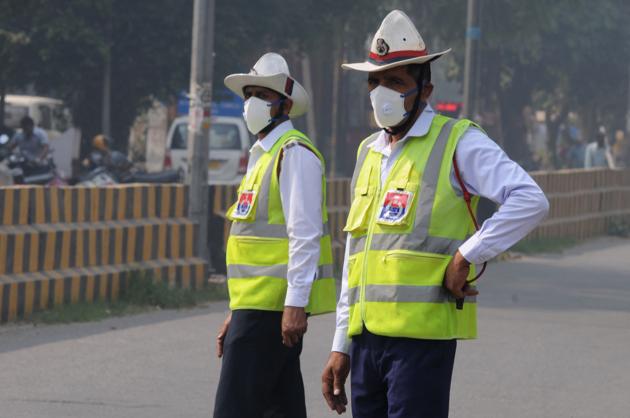 Traffic cops wear air purifying masks as they man traffic on Sunday. (Parveen Kumar/HT PHOTO) Traffic cops wear air purifying masks as they man traffic on Sunday. (Parveen Kumar/HT PHOTO)
