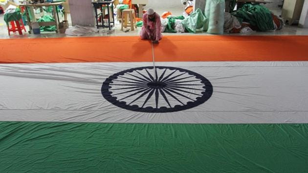 Workers in a flag factory at Bhiwandi give final touches to the tricolour.(Praful Gangurde/ Hindustan Times)