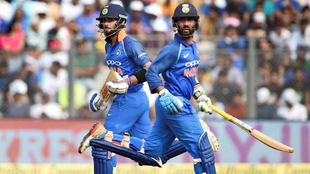 Virat Kohli and Dinesh Kartik running between the wicket during the first ODI. (PTI)