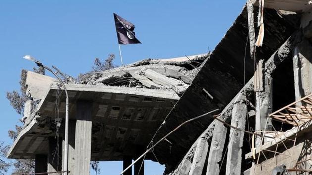 A flag of Islamic State militants is pictured above a destroyed house near the Clock Square in Raqqa, Syria. (Reuters) A flag of Islamic State militants is pictured above a destroyed house near the Clock Square in Raqqa, Syria. (Reuters)