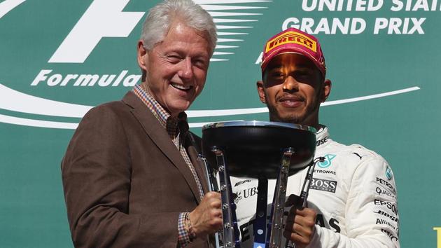 Lewis Hamilton was given the trophy by former President of the USA Bill Clinton. (AFP) Lewis Hamilton was given the trophy by former President of the USA Bill Clinton. (AFP)