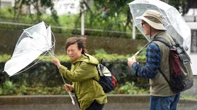 A woman’s umbrella is turned inside out as strong winds sweep through Tokyo with Typhoon Lan barreling towards Japan on October 22, 2017. Heavy rains in the days ahead of Lan making landfall triggered landslides and delayed voting as millions struggled to the polls for the national election over the weekend. (Kazuhiro Nogi / AFP) A woman’s umbrella is turned inside out as strong winds sweep through Tokyo with Typhoon Lan barreling towards Japan on October 22, 2017. Heavy rains in the days ahead of Lan making landfall triggered landslides and delayed voting as millions struggled to the polls for the national election over the weekend. (Kazuhiro Nogi / AFP)