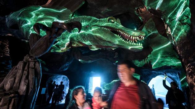 Visitors walk under a robotic dinosaur structure in Aquatis. More than just a visitor attraction, Aquatis (Aqua for water, T for ‘terra’ or earth, I for innovation and S for science) is a scientific, technological, cultural and sustainable project. (Fabrice Coffrini / AFP) Visitors walk under a robotic dinosaur structure in Aquatis. More than just a visitor attraction, Aquatis (Aqua for water, T for ‘terra’ or earth, I for innovation and S for science) is a scientific, technological, cultural and sustainable project. (Fabrice Coffrini / AFP)