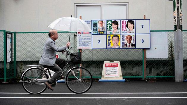 A man walks past posters of Japanese candidates ahead of the general election in Koshigaya, on October 20, 2017. The storm dumped torrential rain over much of Japan during the weekend, packing gusts up to 198 kms per hour, the Met agency said. On Saturday, voters on remote southern islands in the path of the storm cast ballots early, heeding a call from Abe but turnout excluding early voting was at record low levels, the government said. (Behrouz Mehri / AFP) A man walks past posters of Japanese candidates ahead of the general election in Koshigaya, on October 20, 2017. The storm dumped torrential rain over much of Japan during the weekend, packing gusts up to 198 kms per hour, the Met agency said. On Saturday, voters on remote southern islands in the path of the storm cast ballots early, heeding a call from Abe but turnout excluding early voting was at record low levels, the government said. (Behrouz Mehri / AFP)