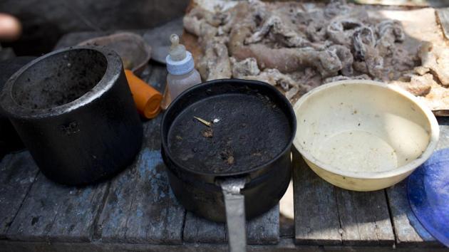 Empty cooking pots and a baby bottle sit in Simone Batista’s outdoor kitchen where she lives with her 1-year-old son in Rio de Janeiro’s Jardim Gramacho slum. Batista said she was reduced to cooking over burning wood after her gas tank was stolen. (Silvia Izquierdo / AP)