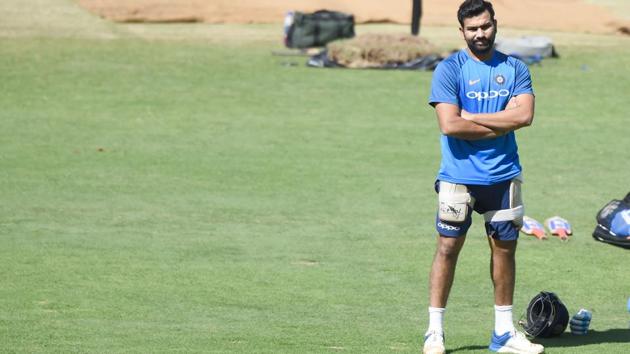 Indian cricketer Rohit Sharma waits for his batting pads during the training session. (AFP) 