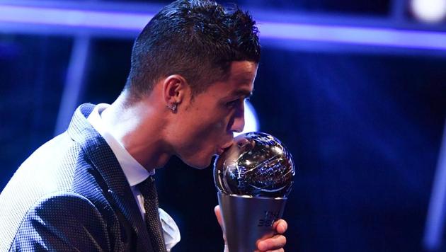 Real Madrid and Portugal forward Cristiano Ronaldo kisses the trophy after winning The Best FIFA Men's Player of 2017 award. (AFP)