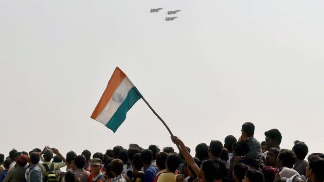 A member of the crowd waves the national flag as Indian Air Force aircraft fly over the Lucknow-Agra Expressway during an IAF drill in Bangarmau, Unnao district. (Nand Kumar / PTI) A member of the crowd waves the national flag as Indian Air Force aircraft fly over the Lucknow-Agra Expressway during an IAF drill in Bangarmau, Unnao district. (Nand Kumar / PTI)