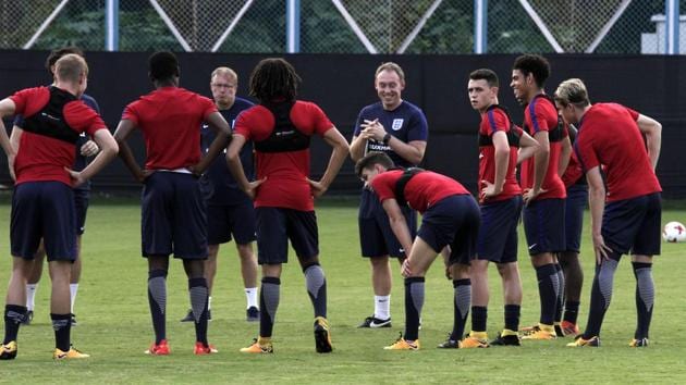England team coach Steven Cooper, fifth right, interact with players during the training session. (AP)