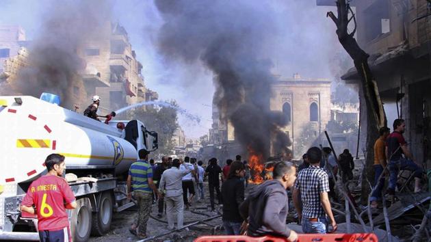 Civil defense workers putting out a fire as Syrian citizens gather after an airstrike hit a market in Maaret al-Numan, southern Idlib, Syria, on October 8. (AP file) Civil defense workers putting out a fire as Syrian citizens gather after an airstrike hit a market in Maaret al-Numan, southern Idlib, Syria, on October 8. (AP file)