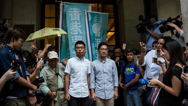 Pro-democracy activists and Demosisto members Joshua Wong (centre L) and Nathan Law (centre R) speak to the media outside the Court of Final Appeal after their bail applications were successful at Hong Kong's highest court on October 24, 2017. (AFP Photo) Pro-democracy activists and Demosisto members Joshua Wong (centre L) and Nathan Law (centre R) speak to the media outside the Court of Final Appeal after their bail applications were successful at Hong Kong's highest court on October 24, 2017. (AFP Photo)
