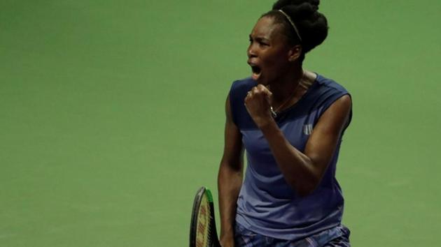 Venus Williams celebrates her win against Latvia's Jelena Ostapenko at the WTA Finals in Singapore on Tuesday.(REUTERS)