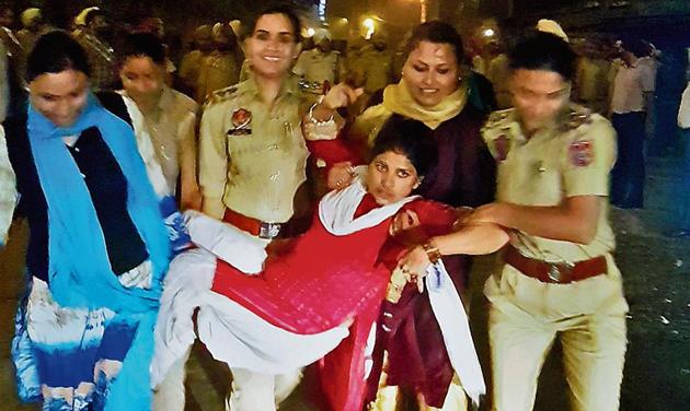 Police officials taking away one of the anganwadi workers from the protest site in Patiala, late on Monday. (Bharat Bhushan/HT) Police officials taking away one of the anganwadi workers from the protest site in Patiala, late on Monday. (Bharat Bhushan/HT)