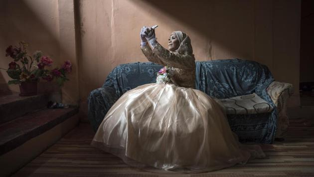 Katty Malang Mikunug takes a selfie in her wedding dress in Saguiaran, Philippines. Philippine President Rodrigo Duterte declared Marawi liberated following the death of Abu Sayyaf leader Isnilon Hapilon and one of the Maute brothers, Omar Maute, after nearly five months of fierce urban battle inside the besieged city. The fighting started May 23, 2017 and left more than 1,000 dead, and displaced at least 400,000 people. (Jes Aznar / Getty Images)