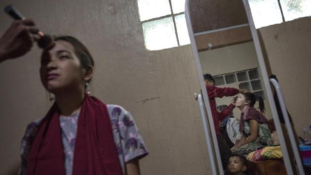 Friends and family members get their makeup done before the wedding of Katty Malang Mikunug and Paulo Mamayo Ambor. (Jes Aznar / Getty Images)