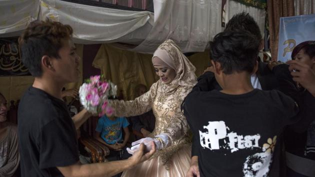 Bride Katty Malang Mikunug (C), dances with family and friends during the celebrations. (Jes Aznar / Getty Images)