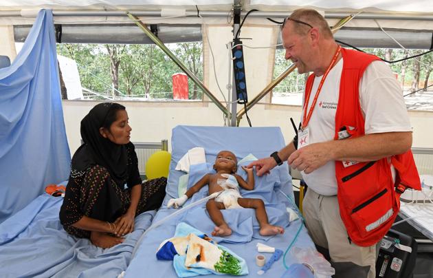 Rohingya refugee Halima accompanies her eight-month-old son Muhammed Hares as he is treated at the Red Cross clinic in Kutupalong refugee camp in Ukhia. With 210 hospital beds available for more than 900,000 people living with little access to clean water, sanitation or medical care, the refugees’ situation is a ‘time bomb ticking toward a full-blown health crisis, said Joanne Liu, the international president of Doctors Without Borders. (Tauseef Mustafa / AFP)