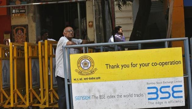 A man looks at a screen across the road displaying the Sensex on the facade of the Bombay Stock Exchange (BSE) building. (Reuters File) A man looks at a screen across the road displaying the Sensex on the facade of the Bombay Stock Exchange (BSE) building. (Reuters File)