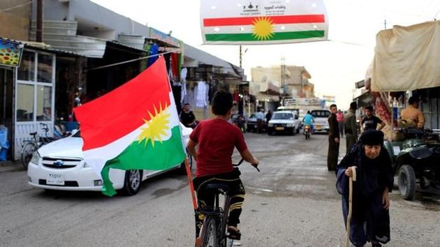 A boy rides a bicycle with the flag of Kurdistan in Tuz Khurmato, Iraq. (Reuters) A boy rides a bicycle with the flag of Kurdistan in Tuz Khurmato, Iraq. (Reuters)