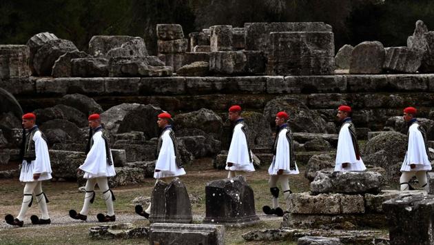 Greek Presidential guards, or Evzones, walk across the ancient archaeological site during the lighting ceremony of the Olympic flame. The traditional ceremony, introduced for the first time during the 1936 Berlin Olympics, did not benefit this time from the Greek sun playing a spoilt sport. (Aris messinis / AFP)