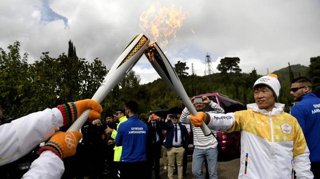 The Olympic flame was then handed over to former Manchester United soccer player Park Ji-sung. ‘As a sports person I have been watching the Olympics throughout my life, and I really wanted to participate, to be involved in the Olympics,’ Park said afterwards. (Aris messinis / AFP)