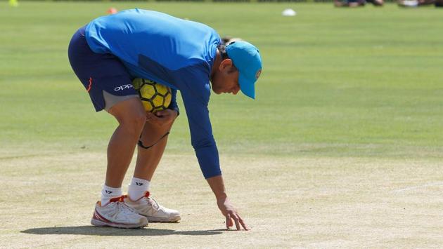 MS Dhoni inspects the pitch in Pune ahead of the India vs New Zealand 2nd ODI. Pune pitch curator Pandurang Salgaonkar has been charged with pitch-fixing by BCCI bosses.(BCCI)