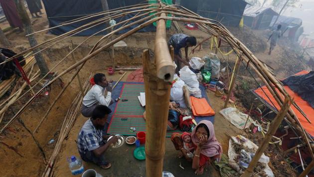 A Rohingya refugee family eats as they sit inside their semi constructed shelter at Kutupalong refugee camp near Cox’s Bazar, Bangladesh. More than 600,000 Rohingya from northern Rakhine have fled to Bangladesh since August 25, 2017 when Myanmar security forces began a scorched-earth campaign against their villages. These new arrivals join more than 300,000 Rohingya who had escaped in recent years. (Adnan Abidi / REUTERS)