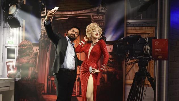 A visitor poses with the wax figure of the Marilyn Monroe, American actress and model. The ticket fee for the museum is Rs.960 for adults and Rs.760 for children. (Raj K Raj / HT PHOTO)