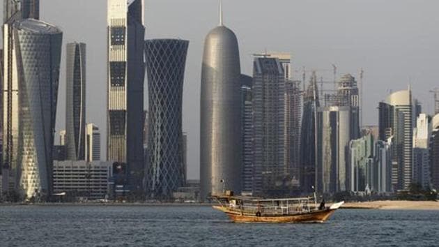A traditional dhow floats in the Corniche Bay of Doha, Qatar, with tall buildings of the financial district in the background. (AP File Photo) A traditional dhow floats in the Corniche Bay of Doha, Qatar, with tall buildings of the financial district in the background. (AP File Photo)
