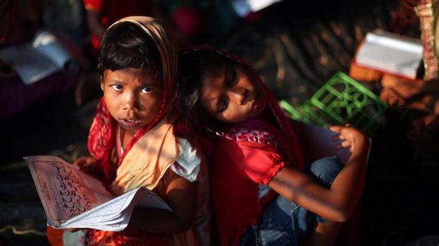 A refugee girl reads the Quran during a lesson at a mosque in Palong Khali refugee camp near Cox's Bazar on October 24, 2017. (Hannah McKay / REUTERS)
