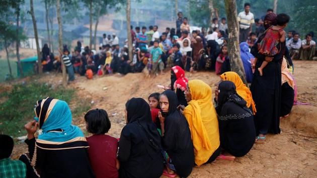 Rohingya refugees sit in a queue as they wait to receive humanitarian aid at Kutupalong refugee camp near Cox's Bazar on October 24, 2017. The UN food aid agency said that it had distributed food to 580,000 people since the crisis erupted, but that it had received less than one-third of the $77 million it needs to aid 1 million people over six months. (Adnan Abidi / REUTERS)