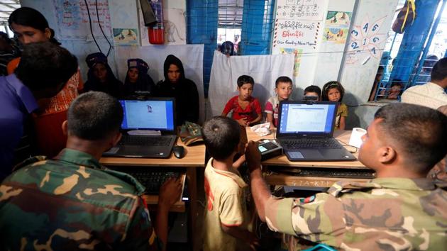 Rohingya refugees are registered by Bangladeshi army personnel at a registration center in Kutupalong refugee camp in Cox's Bazar on October 20, 2017. (Zohra Bensemra / REUTERS)