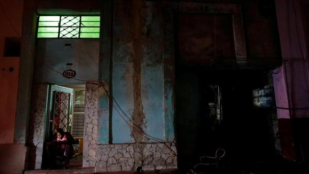 A man sits on his doorstep to connect to a nearby internet hotspot. A tiny share of homes has had broadband access until now, subject to government permission granted to professionals such as academics and journalists. The state telecom monopoly has vowed to hook up the whole island and connected several hundred Havana homes late last year as a pilot project. In September, it said it would roll the service out nationwide by the end of 2017. (Alexandre Meneghini / REUTERS)