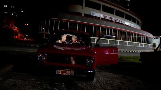 People make a video call inside a car. The dome light is on to provide better lighting for the call. Havana says it has been slow to develop network infrastructure because of high costs, attributed partly to the US trade embargo. Critics say the government fears losing control. (Alexandre Meneghini / REUTERS)