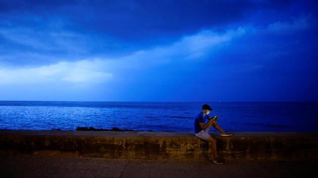 A man connects to a hotspot at the sea front in Havana. In Cuba, the state has the monopoly on print and broadcast media. These hotspots allow users to skim the internet for news and outside perspectives. Among the crowds, black market vendors weave in and out, trying to hawk pre-paid scratchcards allowing Wi-Fi access. The ping of incoming messages and ring of calls fill the air. (Alexandre Meneghini / REUTERS)