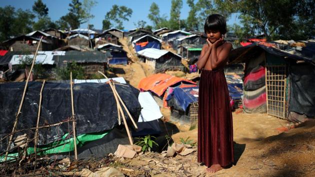 Eight-year-old Zannat, a Rohingya refugee, stands at the entrance to Kutupalong refugee camp near Cox's Bazar on October 23, 2017. (Hannah McKay / REUTERS)