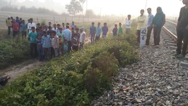 People gather near the railway track in Maigalganj where Afrin Khatoon’s body was found on Wednesday.(HT Photo)