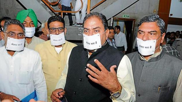 Indian National Lok Dal MLAs wearing paper strips on their mouths as a mark of protest in the Haryana Vidhan Sabha on Wednesday.(HT Photo)