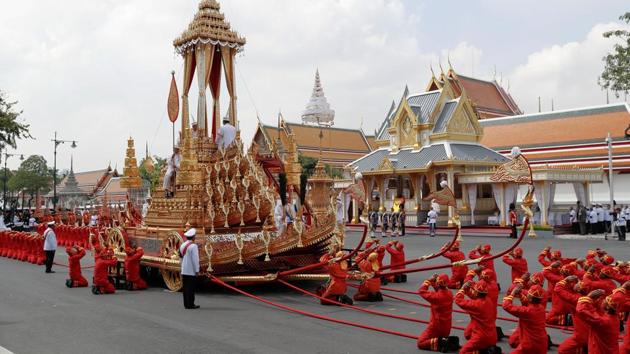 The Royal Urn of King Bhumibol Adulyadej is placed on the Great Victory Chariot during the cremation procession at the Grand Palace in Bangkok. By tradition, deceased royals have been kept upright in elaborate urns but Bhumibol, opted to be put in a coffin, with the urn placed next to it for devotional purposes. The royal chariot is pulled by soldiers using red rope and is one of few items in use for royal funerals since 1796. (Damir Sagolj / REUTERS)