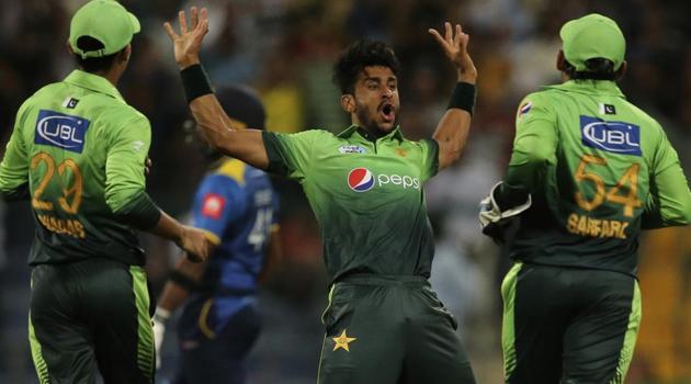 Pakistan cricket team's Hassan Ali celebrates with teammates after taking the wicket of Sri Lanka cricket team's Sachith Pathirana during their first T20I in Abu Dhabi, United Arab Emirates, on Thursday. Get full cricket score and highlights of Pakistan vs Sri Lanka 1st T20 here.(AP)